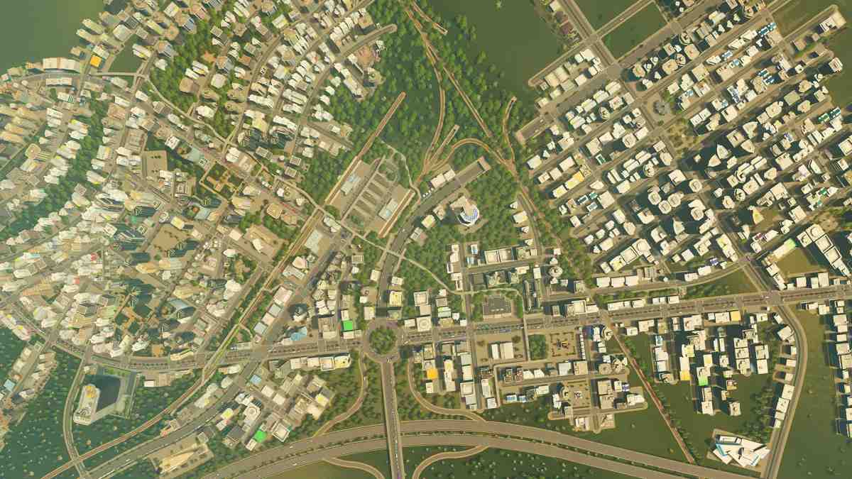 Vue plongeante d'un aménagement urbain dense avec routes, zones résidentielles et commerciales dans Cities: Skylines